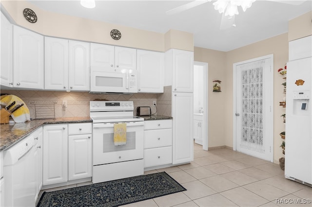 kitchen featuring ceiling fan, backsplash, dark stone counters, white appliances, and white cabinets