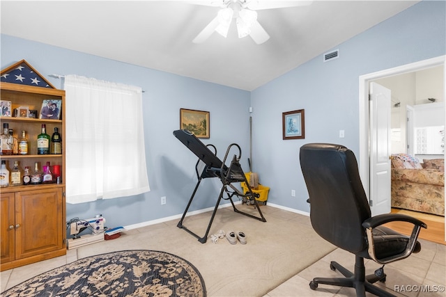 office featuring light carpet, vaulted ceiling, and ceiling fan