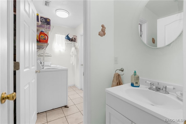 bathroom with tile patterned flooring, vanity, and washer and dryer