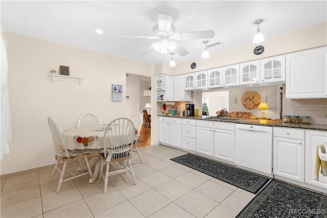 kitchen with dishwasher, backsplash, white cabinetry, and sink