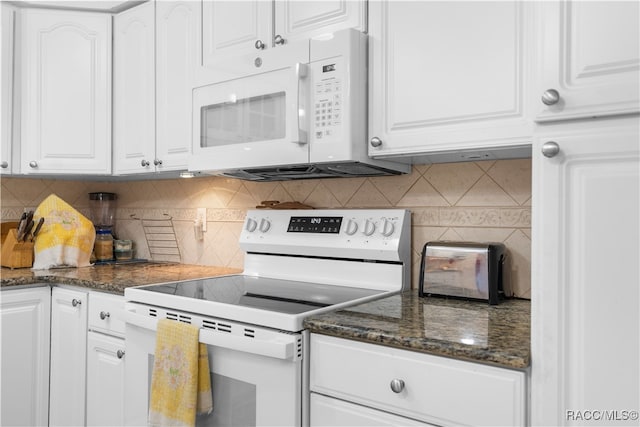 kitchen with white cabinets, decorative backsplash, white appliances, and dark stone counters