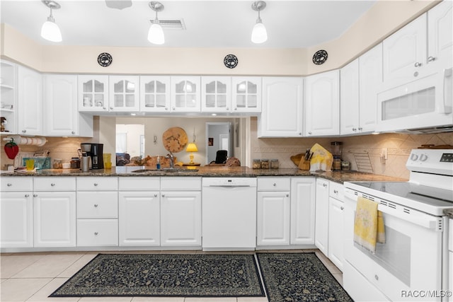 kitchen with white cabinetry, decorative light fixtures, and white appliances