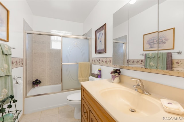 full bathroom with tile patterned floors, vanity, bath / shower combo with glass door, and toilet