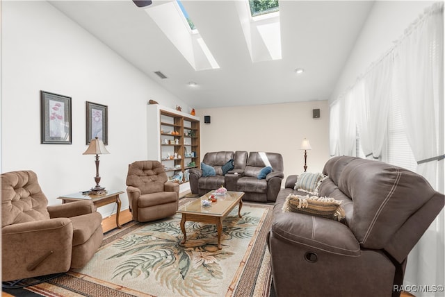 living room featuring wood-type flooring and vaulted ceiling with skylight