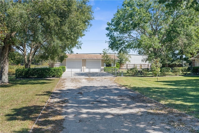 ranch-style house featuring a front yard and a garage