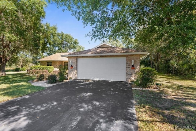 view of home's exterior featuring a garage and a lawn