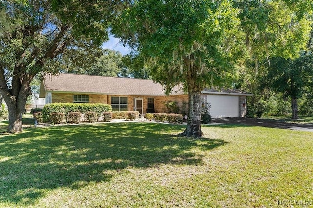 ranch-style home featuring a front lawn and a garage