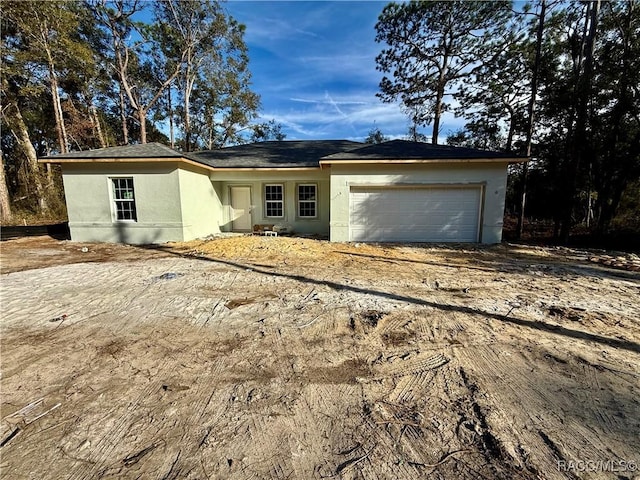 single story home featuring a garage