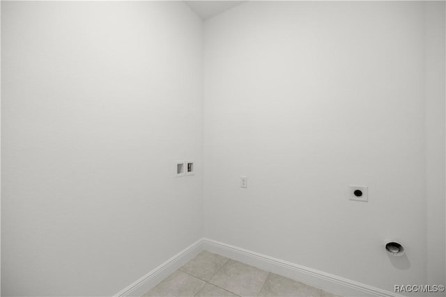 laundry area with electric dryer hookup, washer hookup, and light tile patterned floors