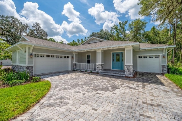 view of front of house featuring covered porch and a garage