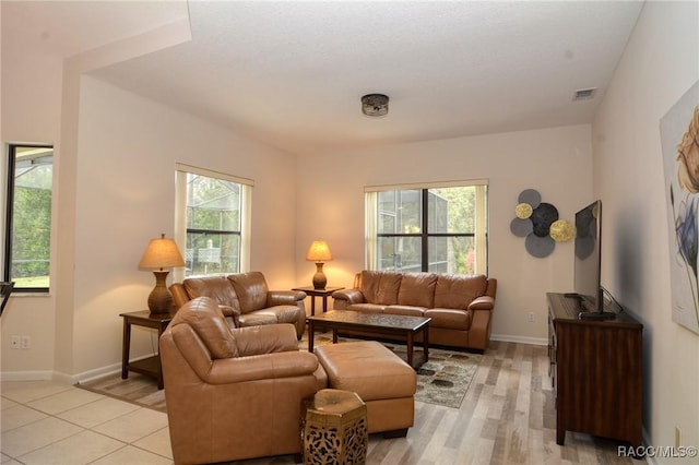 living room featuring plenty of natural light and light wood-type flooring