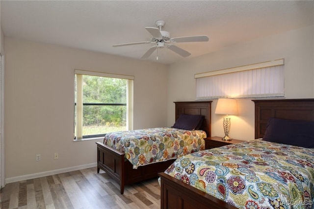 bedroom with ceiling fan and light wood-type flooring