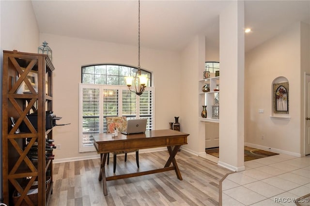 office featuring light hardwood / wood-style flooring, lofted ceiling, and a notable chandelier