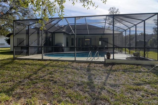 rear view of house featuring a yard and a lanai