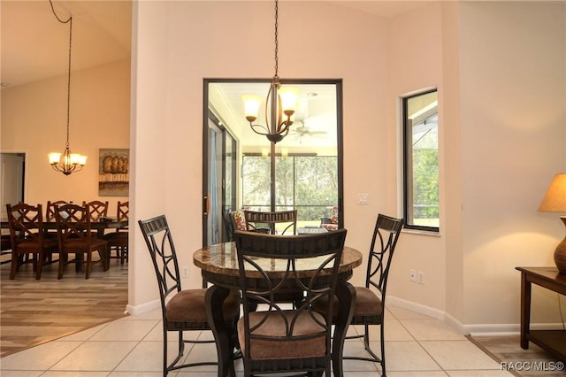 tiled dining room featuring an inviting chandelier