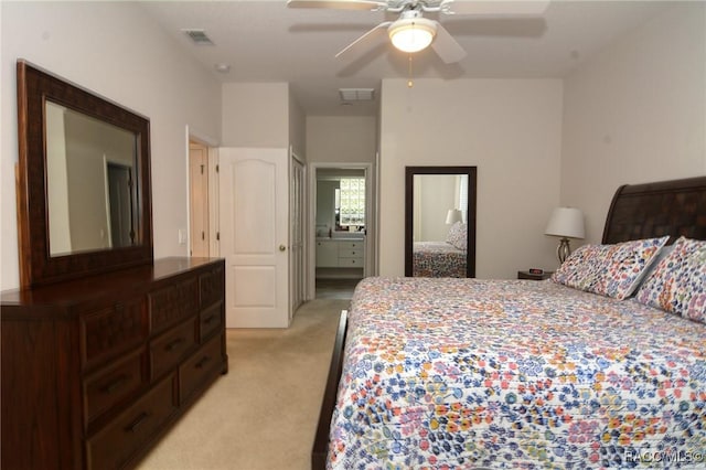 carpeted bedroom featuring ensuite bathroom and ceiling fan