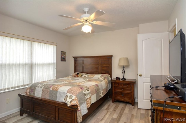 bedroom with ceiling fan and light hardwood / wood-style floors