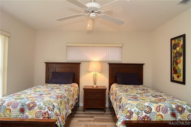 bedroom with light wood-type flooring and ceiling fan