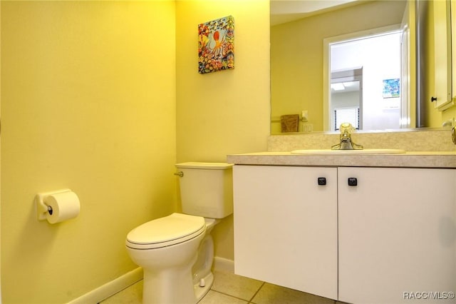 bathroom featuring tile patterned flooring, vanity, and toilet