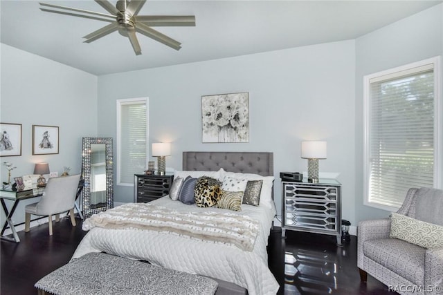 bedroom with dark hardwood / wood-style floors and ceiling fan