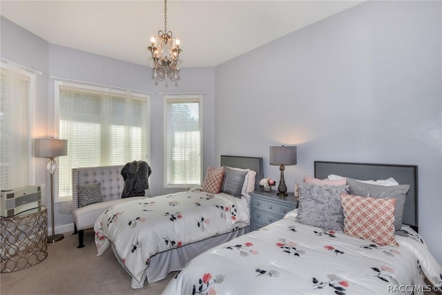 bedroom featuring a chandelier and carpet