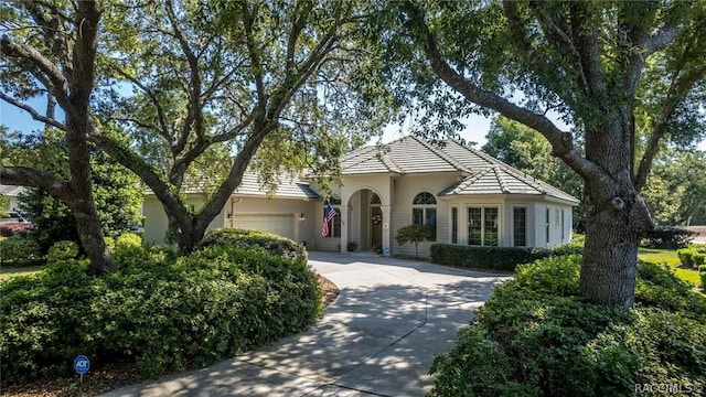 mediterranean / spanish-style home featuring a garage