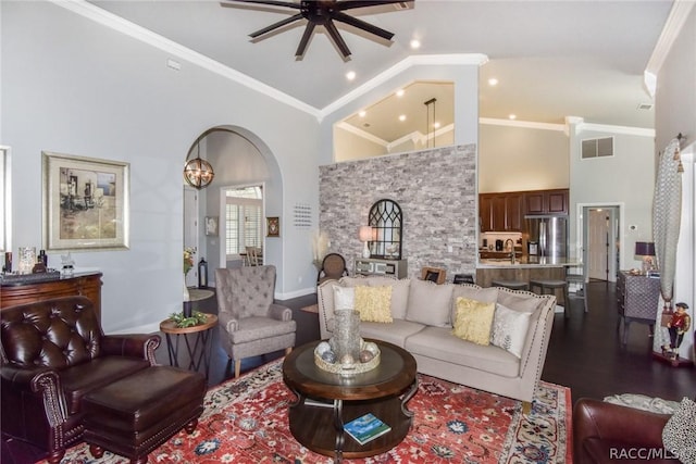 living room with crown molding, dark hardwood / wood-style floors, and high vaulted ceiling