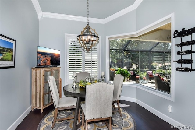 dining room with an inviting chandelier, ornamental molding, and dark hardwood / wood-style flooring