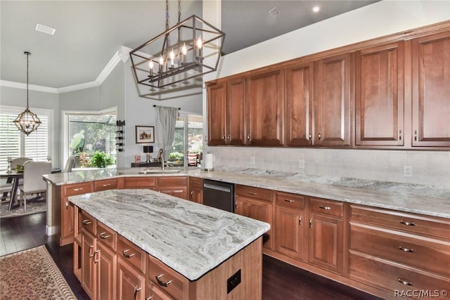 kitchen with sink, decorative light fixtures, stainless steel dishwasher, kitchen peninsula, and a notable chandelier