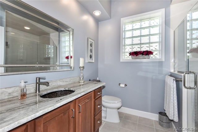 bathroom with vanity, a shower with shower door, tile patterned floors, and toilet