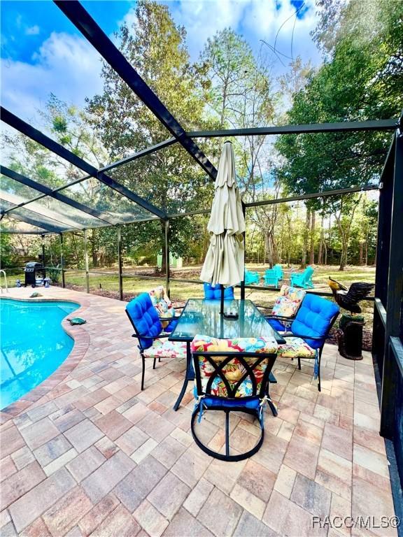 view of patio featuring a lanai