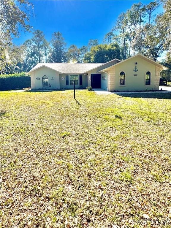 ranch-style home with a front lawn