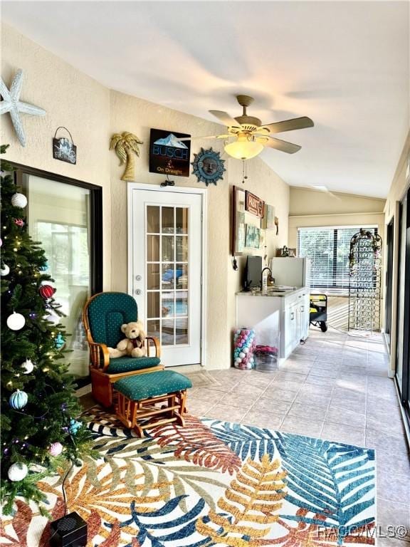 sunroom / solarium featuring ceiling fan and lofted ceiling