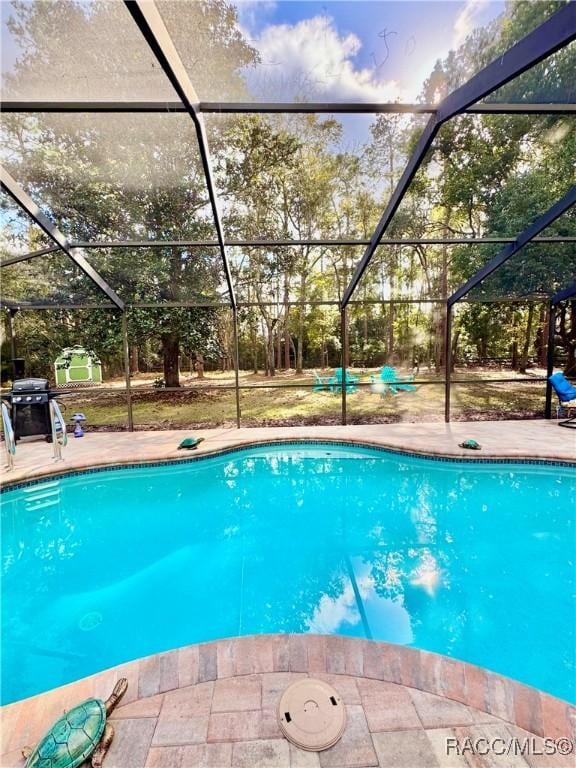 view of pool featuring a lanai and a patio area