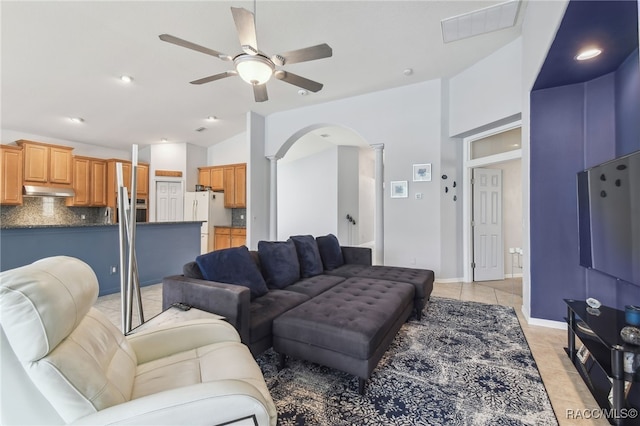 tiled living room with ceiling fan and lofted ceiling