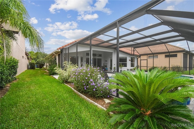 1049 W Lake Valley Ct, Hernando, FL 34442 - back of house with a yard, glass enclosure, a tile roof, and stucco siding