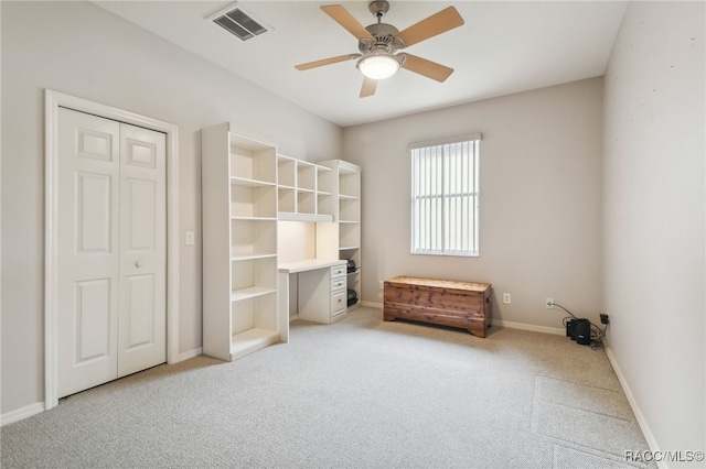 bedroom featuring ceiling fan, light colored carpet, and a closet