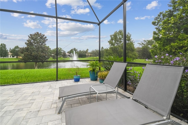 unfurnished sunroom with a water view