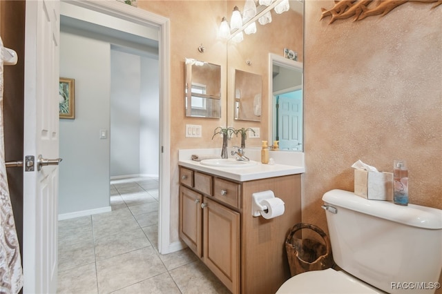 bathroom with tile patterned floors, vanity, and toilet