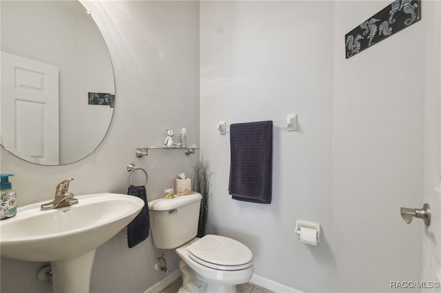 bathroom with tile patterned floors, toilet, and sink