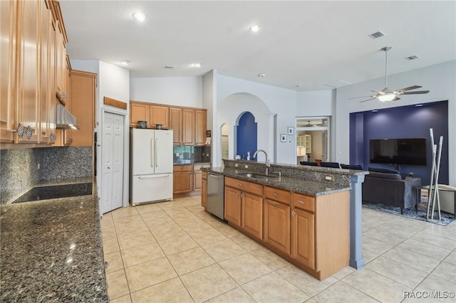 kitchen with dishwasher, lofted ceiling, exhaust hood, white refrigerator, and sink