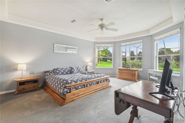 carpeted bedroom with ceiling fan and multiple windows