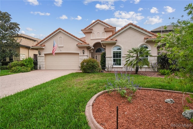 1049 W Lake Valley Ct, Hernando, FL 34442 - mediterranean / spanish house with an attached garage, driveway, stucco siding, a front lawn, and a tiled roof