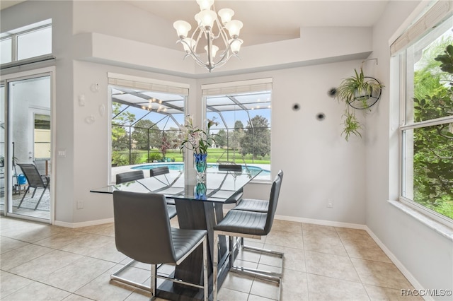 tiled dining area with lofted ceiling and a chandelier