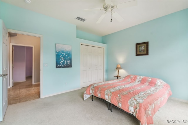 bedroom featuring light carpet, a closet, and ceiling fan