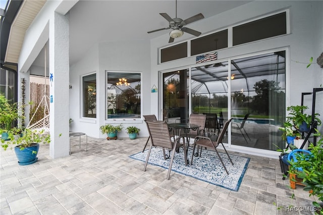 view of patio / terrace with ceiling fan and glass enclosure