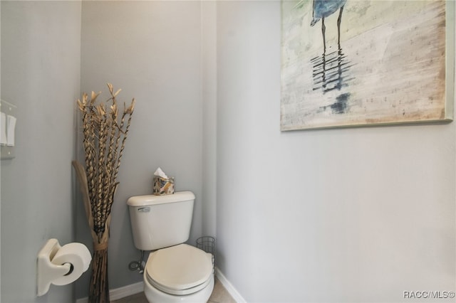 bathroom featuring tile patterned flooring and toilet