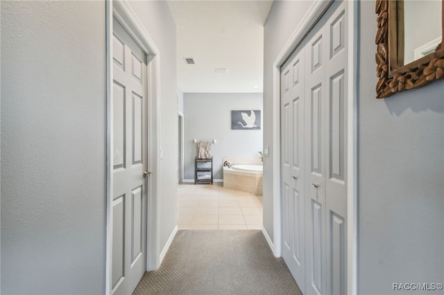 1049 W Lake Valley Ct, Hernando, FL 34442 - hallway featuring tile patterned flooring, carpet floors, and baseboards