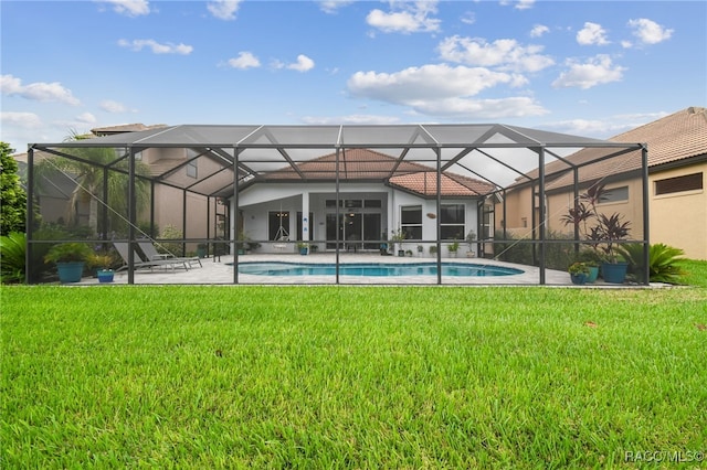 view of swimming pool featuring glass enclosure and a lawn