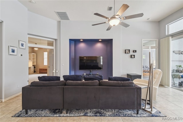 living room featuring light tile patterned floors and ceiling fan